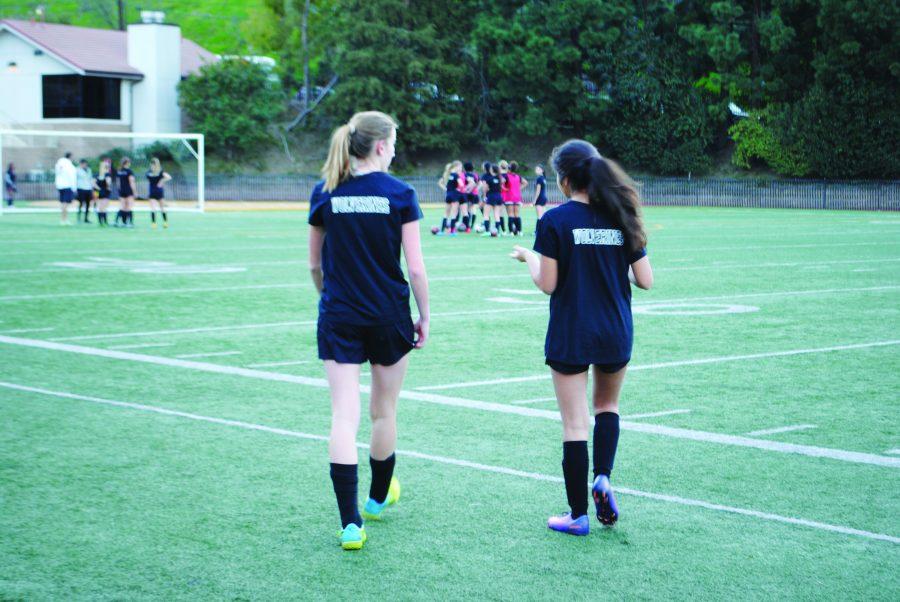 Carly Wallace 20 and Giselle Dalili 20 walk on to field during practice. Credit: Casey Kim20/SPECTRUM