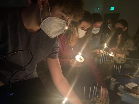 students light menorahs
