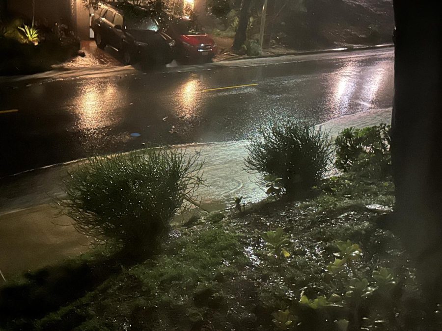 The view of the water rushing down the street and overtaking the sidewalk at the photographers home near the upper school at 9:38 p.m. on Monday, Jan. 9. 