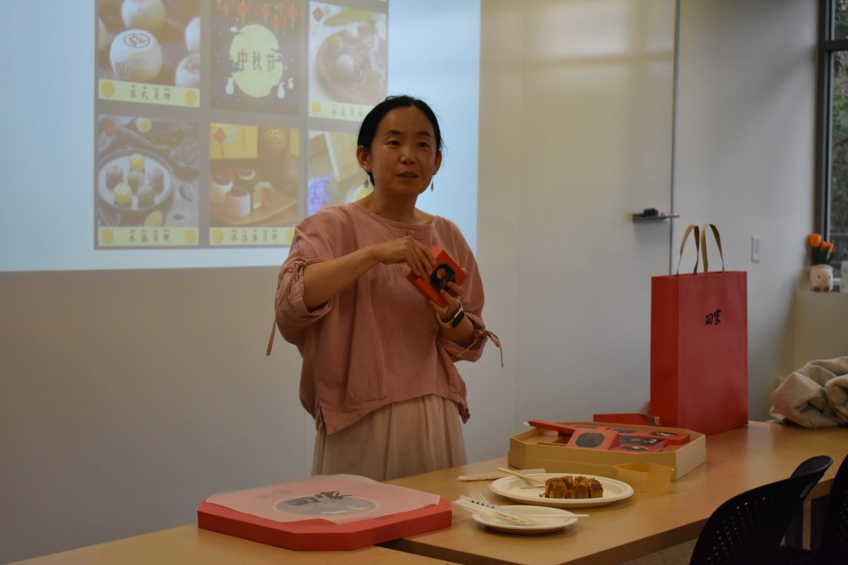 World+Language+teacher+Shuang+Yang+explains+the+different+types+of+mooncakes+to+her+class.+