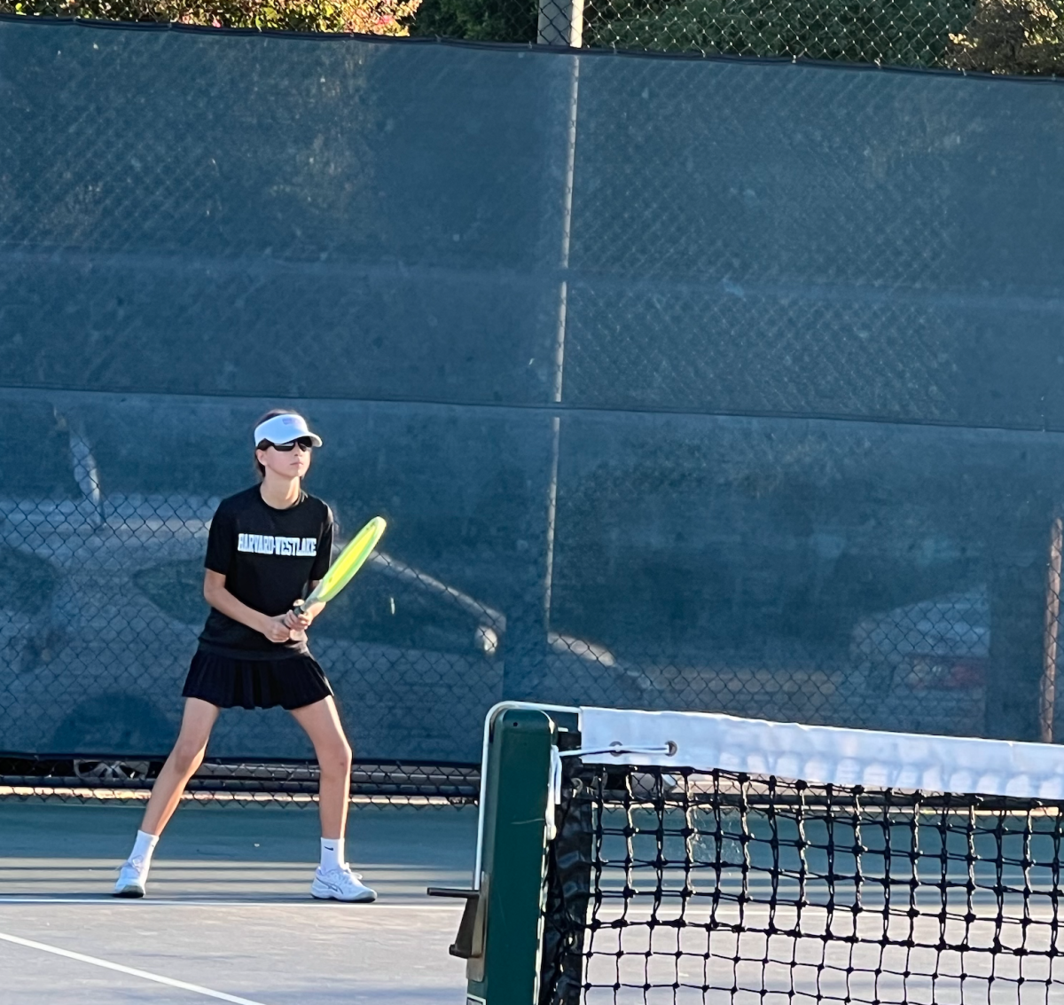 Brooklyn Caras playing tennis against opponent, Paul Revere.