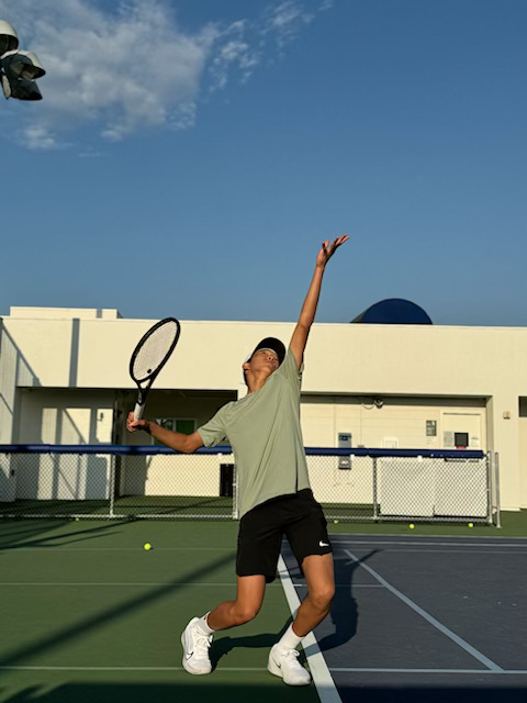 Eric Kim 28 captures his serve with a phone timer.