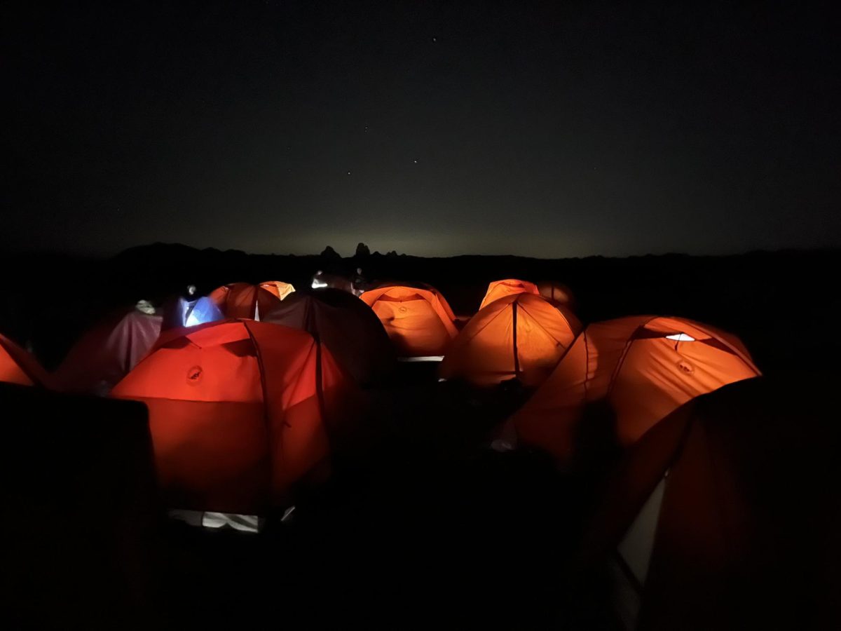 Students relax in their tents after a long day of activities.