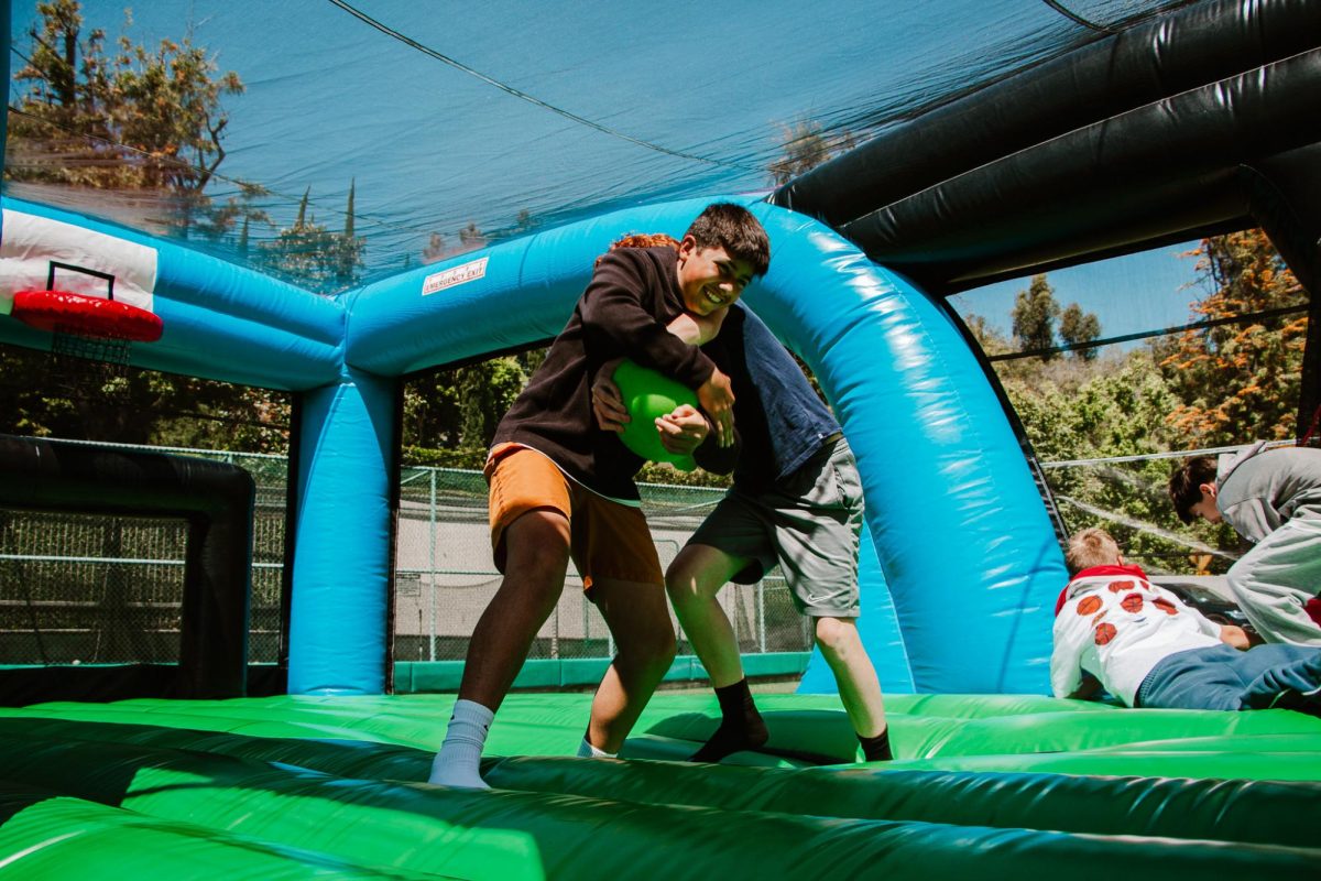 Students compete in a bounce house basketball game during Field Day.
