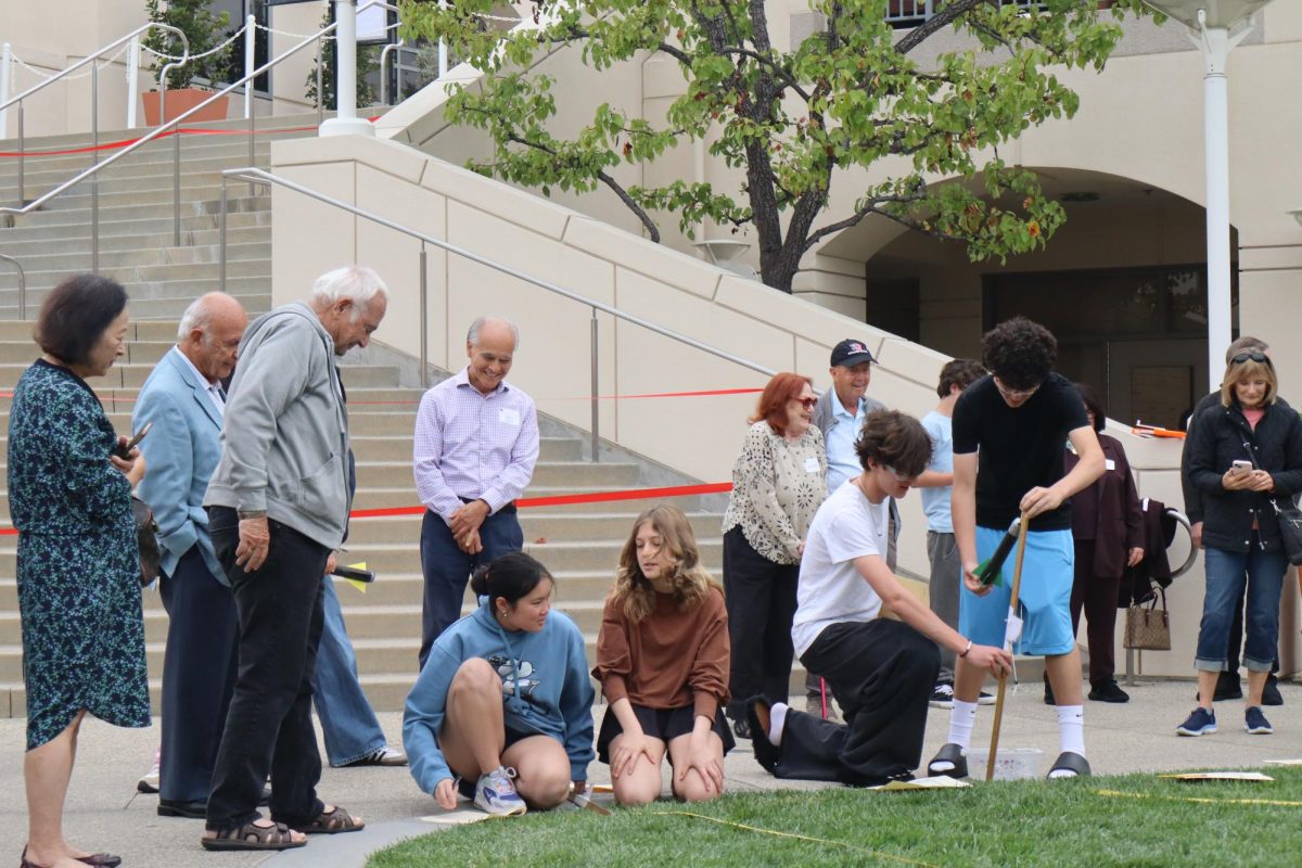 8th grade science class joined with grandparents/special friends doing an experiment on physics. 